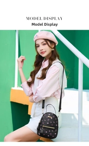 Mini black leather backpack with pink floral pattern shown on a female model