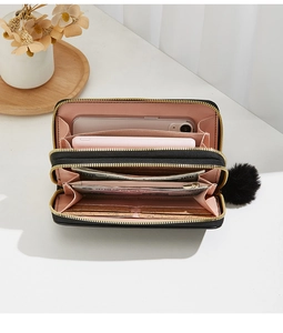 Detail of black double zipper wallet interior with spacious compartments for phone and cards