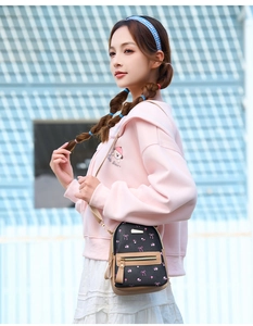 Mini crossbody backpack with bow print and brown leather trim worn by model outdoors