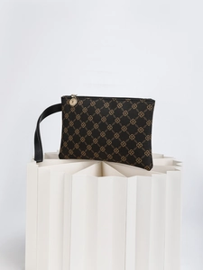 Detail of the monogram clutch featuring an S-chain pattern and gold-tone zipper pull