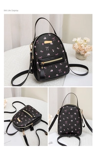 Multiple views of a black mini backpack with pink floral and bow prints and gold zippers
