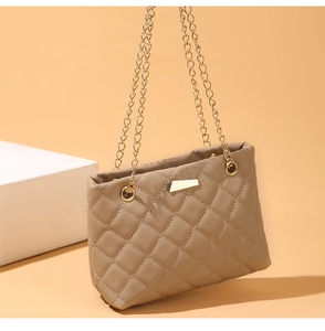 Detailed close-up of quilted khaki PU leather shoulder bag with golden chain and clasp