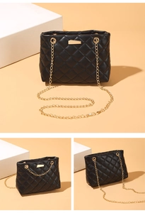 Macro shot of black quilted shoulder bag with gold chain and diamond pattern detail