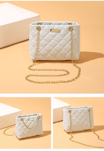 Detail of white quilted chain bag with gold metal clasp and elegant diamond pattern texture