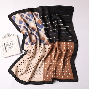 Detail of four-panel scarf featuring plaid, stripes, dots, and cat print patterns