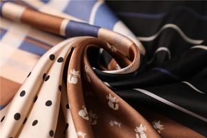 Detail of silk-like scarf featuring polka dots, cats, and vibrant patchwork textures