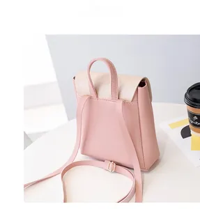 Detail view of mini two-tone PU leather backpack with gold hardware and pink straps