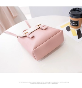 Detail of pink and white mini backpack with gold buckle and lychee leather texture