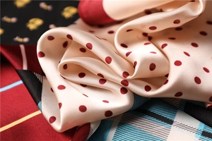 Detailed view of silk scarves with polka dots and stripes showing soft pearly luster