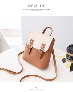 Detail of color-block mini backpack with brown leather straps and gold metal buckles
