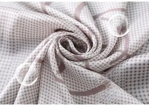 Detailed view of pink houndstooth silk scarf showing soft texture and fluid drape
