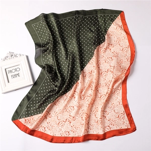 Detail of silk-satin scarf with green polka dots and orange paisley floral pattern