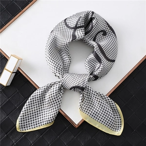 Close-up of houndstooth silk scarf with geometric pattern and contrast border trim