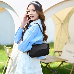 Classic black leather crossbody bag for women featuring a minimalist semi-circular flap design