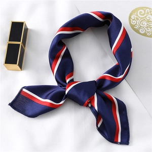 Close-up of red white and blue striped satin square scarf tied in an elegant bow