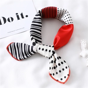 Detail of silk scarf with black white stripes, red blocks and polka dot patterns