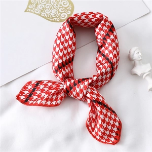 Detail of red and white houndscarf tied as an elegant necktie for OL office style