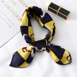 Detailed view of geometric printed silk twilly scarf with navy and burgundy satin texture