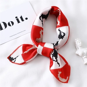 Detail of red and black pixelated horse pattern silk scarf with fine stitched edges