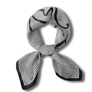 Classic black and white houndstooth silk square scarf tied in an elegant knot