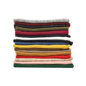 Detailed view of multiple colors of rib-knit neck warmer scarves in a soft texture