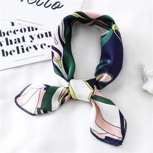 Detail of silk scarf with geometric patterns on a white fabric with decor