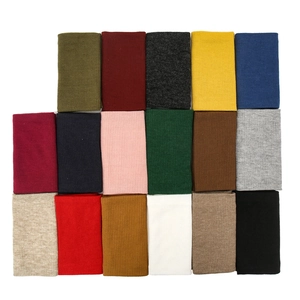 Knitted thermal neck gaiter in various solid colors with ribbed texture for winter warmth