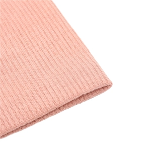 Macro detail of high-quality light pink ribbed knit fabric with soft texture and elasticity