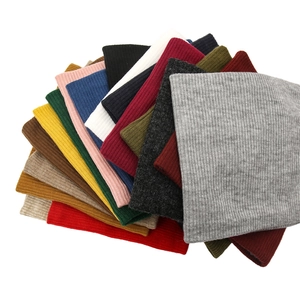 Detailed stack of multi-color ribbed knit neck warmers with soft thermal texture