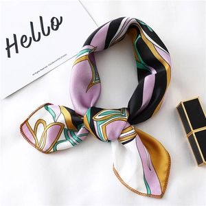 Detail view of abstract geometric silk scarf with violet, yellow and teal patterns