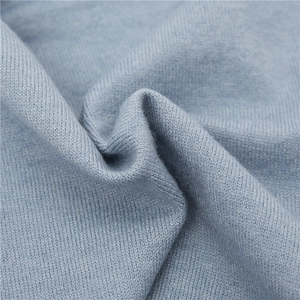 Close-up of light blue knitted neck warmer fabric showing fine texture and softness