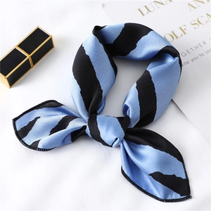 Detail of silk scarf with blue and black tiger stripes used as a stylish neck tie