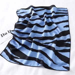 Detail of silk scarf with blue and black zebra pattern showing smooth glossy texture