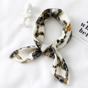 Detail of silk-like scarf featuring leopard rings, golden chains and padlock patterns