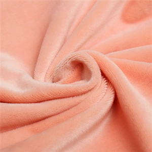 Close-up of soft peach velvet fabric showing plush texture and warmth of the neck warmer