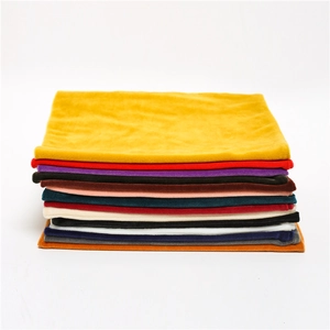 Detailed close-up of colorful velvet neck warmers stacked showing soft plush texture