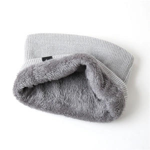 Close-up of thick grey thermal fleece lining and knitted texture on winter neck warmer