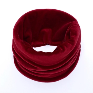 Detail shot of a warm burgundy velvet neck warmer for winter with glossy finish