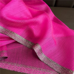 Close-up of bright pink chiffon scarf with silver diamond pattern woven edge
