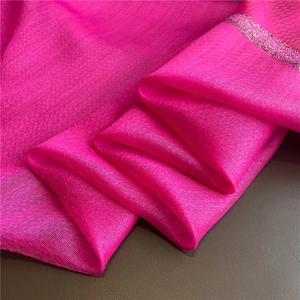 Detailed macro view of bright pink silk scarf texture with shimmering silver edge