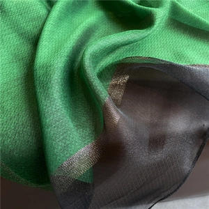 Macro view of silky green and black pinstripe fabric with a soft satin finish sheen