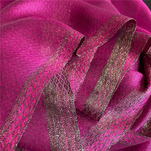Detailed macro view of magenta silk scarf with metallic geometric rhombus embroidery