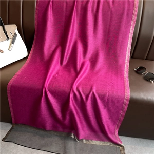 Detail of rose red silk scarf featuring jacquard texture and golden glitter edges