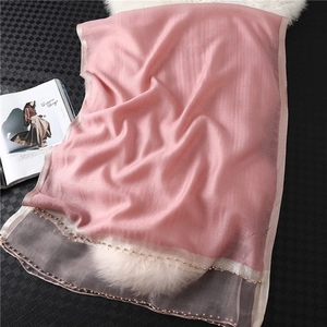 Detail of pink silk scarf showing sheer tulle hem and elegant hand-beaded pearl trim