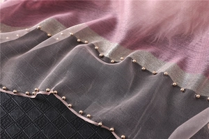 Detail of gradient silk shawl with delicate pleats and gold pearl bead embellishments