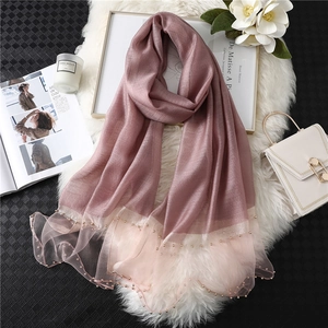 Detail of pink silk scarf featuring hand-stitched pearl beads and elegant organza trim