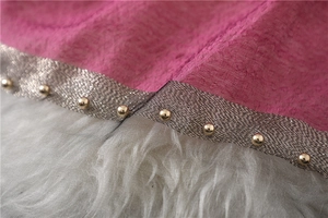Detailed close-up of pink silk scarf with silver mesh edge and gold bead embellishments