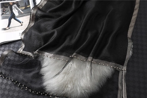 Detailed shot of black silk-blend scarf with gold trim and white pearl bead embellishments