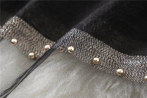 Detail of black silk scarf featuring golden studs on silver metallic woven trim and mesh