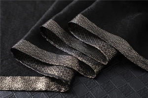 Detail of black silk wool scarf with bronze gold metallic textured geometric border